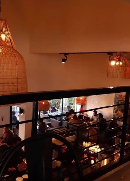 The mezzanine looking down over the full room at night