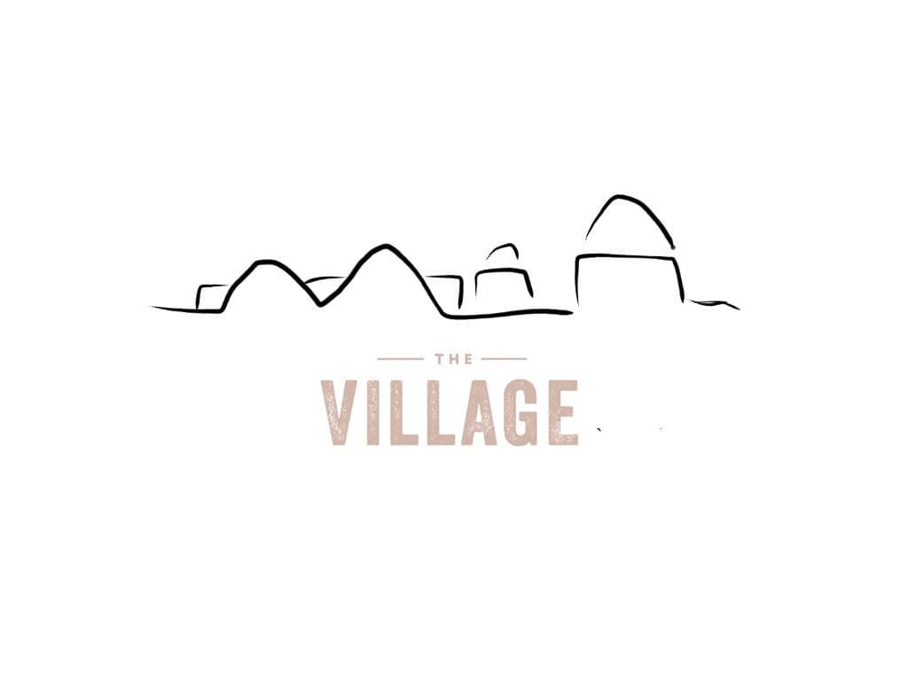 2017 logo: the domes drawn as a single outline, “THE VILLAGE” in beige
