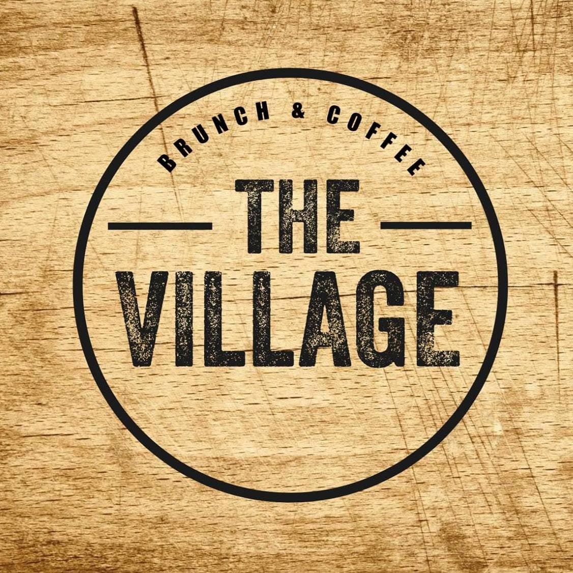 May 2018 logo: the same circular stamp on a wood-grain ground