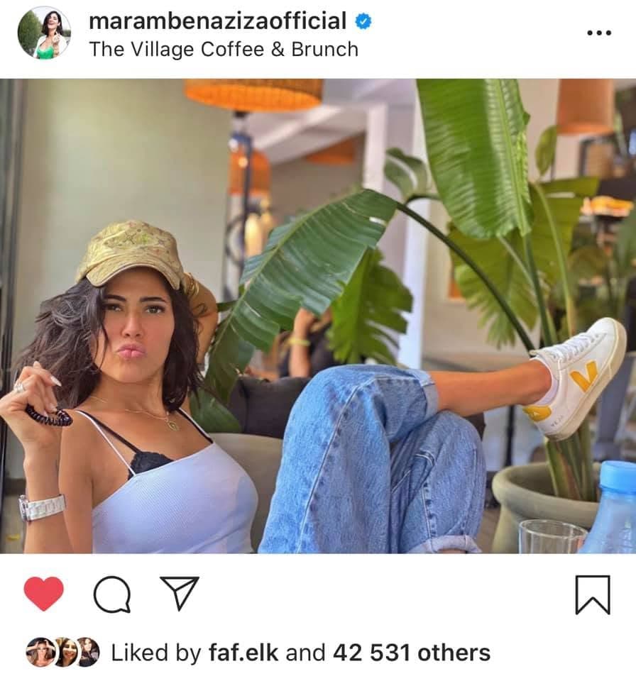 Instagram post tagged at The Village: a guest sitting beside the large banana leaves