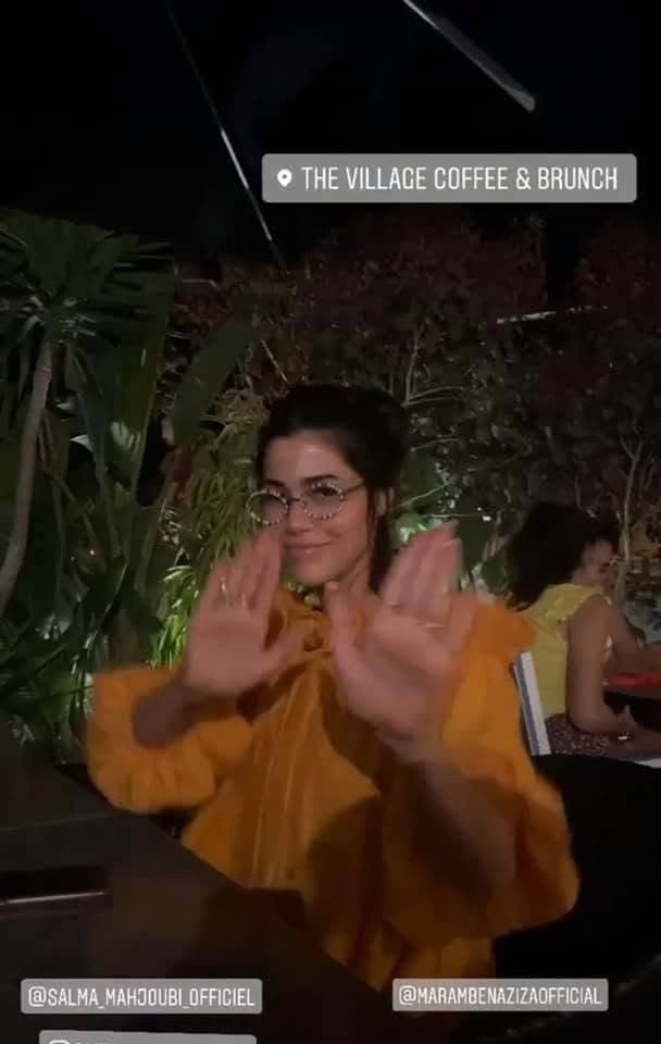 Instagram story tagged at The Village: a guest on the terrace at night, under the lit plants